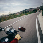 POV motorcycle driver on empty road
