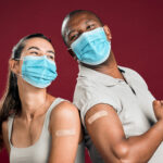 smiling-adults-wearing-masks-show-vaccination-patc-2026-09-22-05-57-27-utc