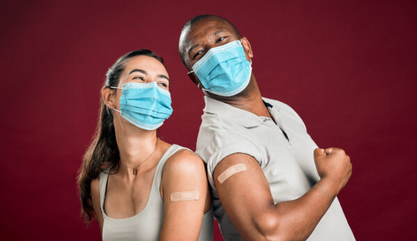 smiling-adults-wearing-masks-show-vaccination-patc-2026-09-22-05-57-27-utc