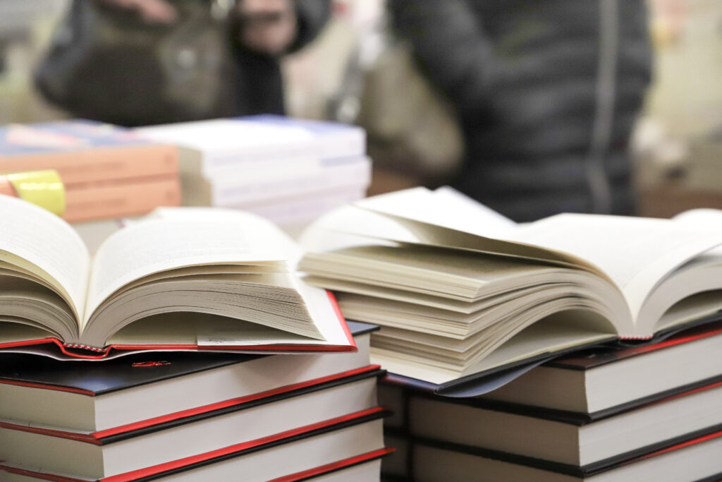 stack of books on the table. open book