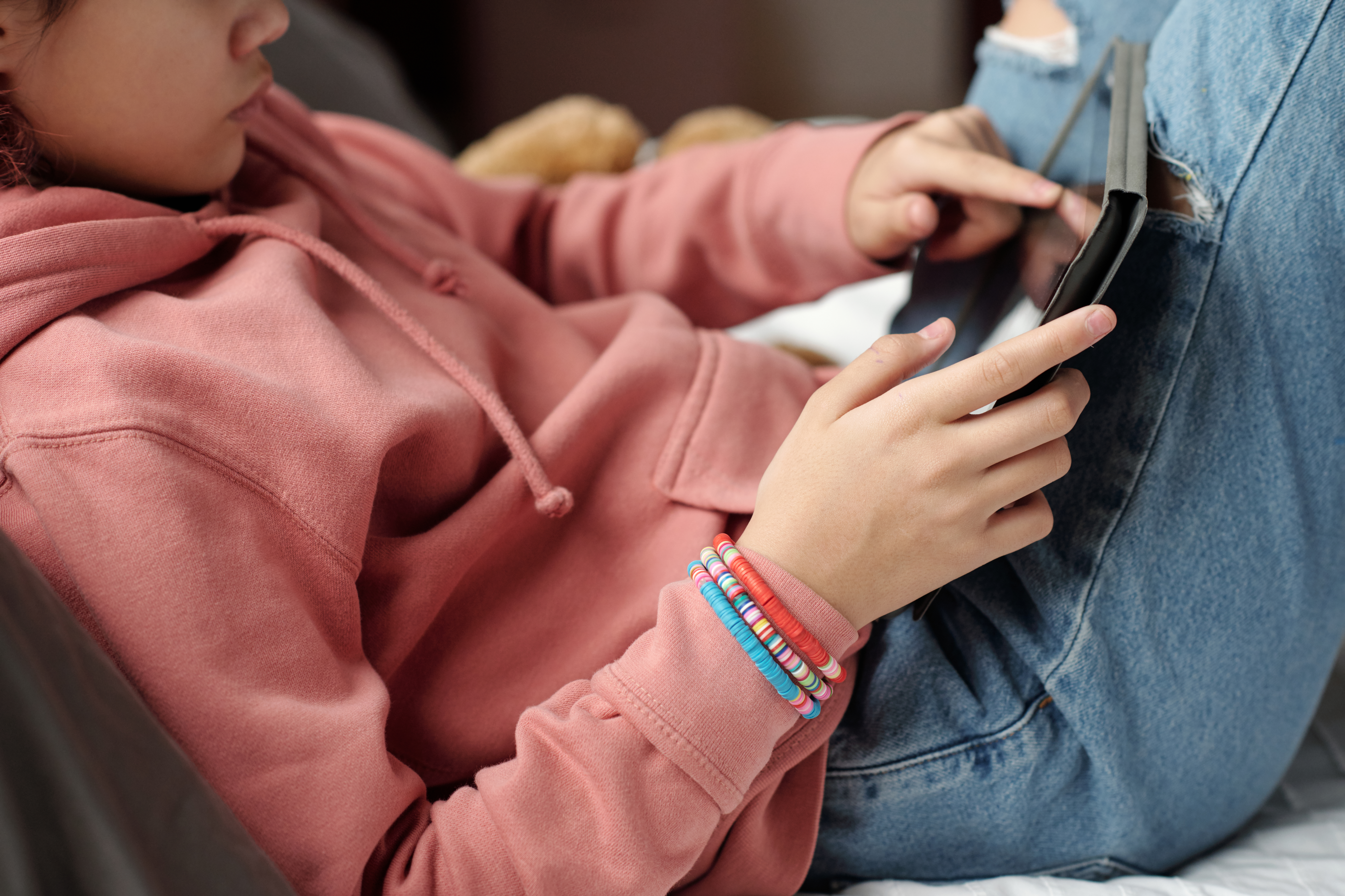 Teenage girl pointing at tablet screen
